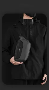 Close-up of minimalist black crossbody chest bag with adjustable strap and zip closure