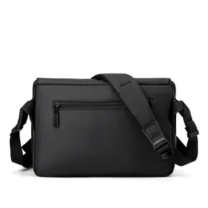 Minimalist black waterproof crossbody messenger bag for men with padded strap on white background