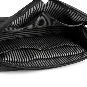 Black crossbody bag internal view featuring black and white striped lining and pockets
