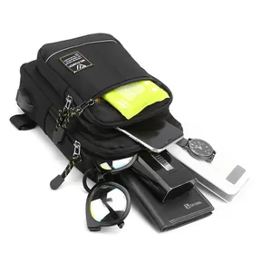 Men's black nylon chest bag with USB port and multiple zippered compartments for travel