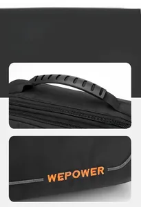 Detail of WEPOWER black bag showing the ergonomic handle and orange embroidered logo