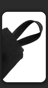 Detail shot of heavy-duty black nylon strap and reinforced handle stitching for the chest bag