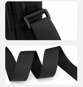 Detail of square buckle link and comfortable wide shoulder strap on black crossbody bag