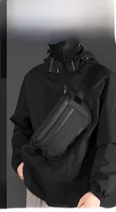 Detail view of black nylon chest bag with waterproof zipper on technical functional jacket