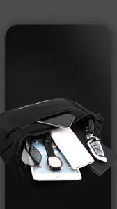 Macro shot of black nylon crossbody bag showing multiple pockets and EDC gear organization
