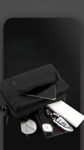 Detailed top view of a nylon shoulder bag with multi-layer storage for tech and accessories
