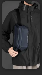 Detail of navy blue waterproof nylon chest bag featuring dual zippers and durable fabric