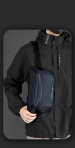 Detail of dark blue waterproof nylon chest bag with adjustable strap and dual zippers