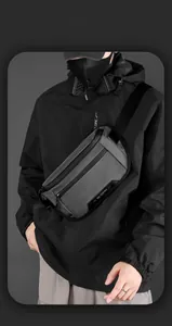 Detail of grey nylon crossbody bag featuring waterproof zippers and adjustable tech strap