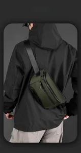 Detail of army green outdoor tactical crossbody bag with multi-layer zipper pockets