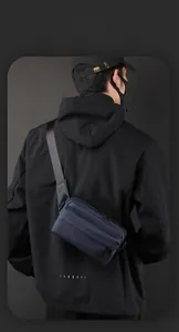 Close-up of matte dark blue nylon crossbody bag featuring smart storage with zip closure