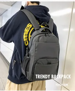 Close-up of charcoal grey nylon backpack showing mesh side pockets and padded shoulder straps