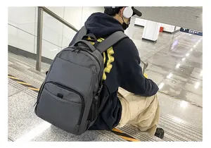 Detailed view of gray nylon backpack worn on shoulders for daily city commuting