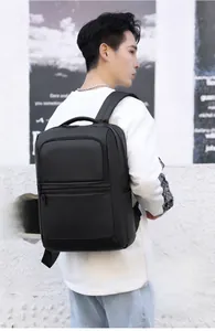 Man wearing large black business backpack showing side view and wide shoulder straps