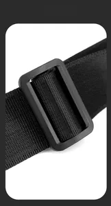 Detail shot of durable nylon strap and adjustable matte buckle on a black crossbody bag