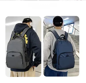 Detail view of grey and navy nylon backpacks with side mesh pockets and shoulder straps