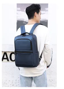 Detail of waterproof navy blue business backpack with triple zipper compartments and wide straps