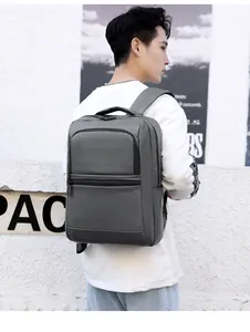 Gray waterproof business backpack with ergonomic straps shown on a model