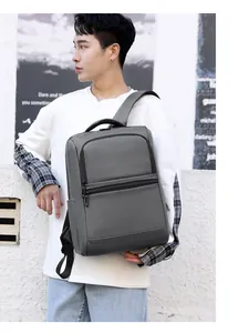 Close-up of waterproof grey business backpack featuring reinforced handle and zipper pocket