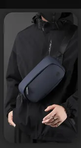 Detail of navy blue waterproof crossbody chest bag with circular logo and zipper pulls