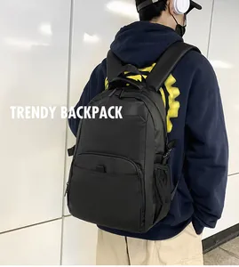 Detail of black nylon backpack featuring large main compartment and mesh side pocket