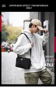 Detailed view of a black nylon messenger bag with adjustable strap on a male model
