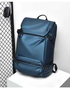 Detail view of the waterproof fabric texture and buckle system on the navy blue backpack