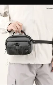 Detail of waterproof nylon crossbody bag with camouflage pattern and sturdy top handle