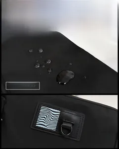 Detail of waterproof black fabric and compact D-ring hook on men's crossbody bag