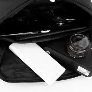 Spacious interior of a black tactical chest bag with dedicated digital gear compartments