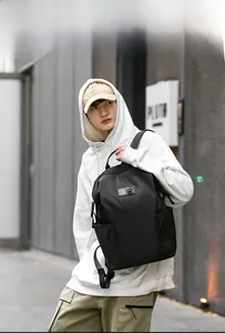 Outdoor model wearing black casual backpack with wear-resistant nylon fabric for travel