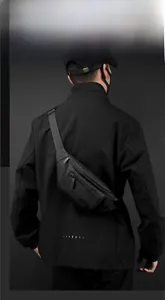 Close-up of black waterproof chest bag with multiple zipper compartments and matte texture
