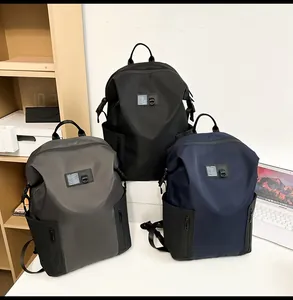 Three men's casual backpacks in black, grey, and navy blue shown in a study setting