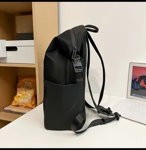 Side detail of a black nylon backpack featuring adjustable side buckles and large pockets