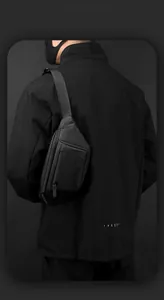Detail of waterproof matte black men's chest bag featuring zipper pockets and adjustable strap