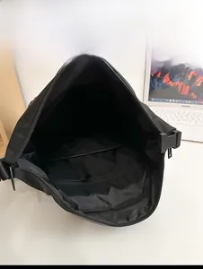 Internal view of black travel backpack showing zippered pocket and spacious compartment