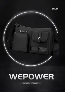 Detailed front view of black crossbody bag showing multiple pockets and metal buckles
