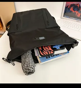 Internal layout of black waterproof nylon backpack showing laptop and multi-pocket storage