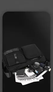 Macro view of the spacious inner compartments of this black waterproof messenger bag