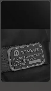 Close-up of durable rubber logo tag and high-density nylon texture on black crossbody bag