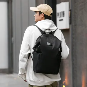 Men's black casual backpack for travel and school shown in a stylish outdoor street view