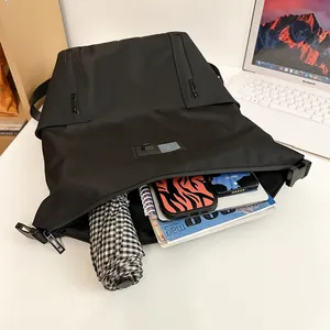 Modern black nylon backpack with multiple pockets showing spacious interior storage