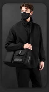 Detail of waterproof nylon crossbody bag featuring front pocket with hardware buckle and strap