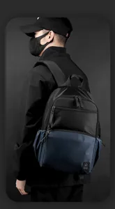Detail of waterproof laptop backpack with WE POWER logo and multi-layer zippers