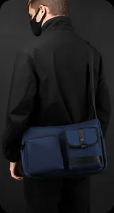 Detail view of durable navy blue messenger bag featuring metal buckles and fabric texture