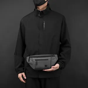 Minimalist dark grey crossbody chest bag for outdoor sports worn by a male model