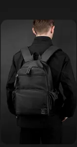 Modern black waterproof commuter backpack with spacious compartments and padded straps