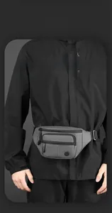Detail of dark grey multi-pocket fanny pack with adjustable strap and smart storage