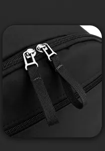Detail view of durable metal zippers and high-density nylon fabric on black laptop backpack