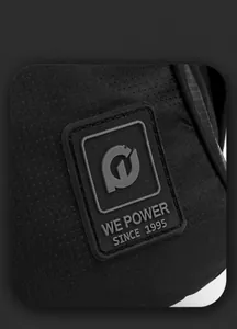 Detail view of the black nylon backpack showing embossed logo patch and texture